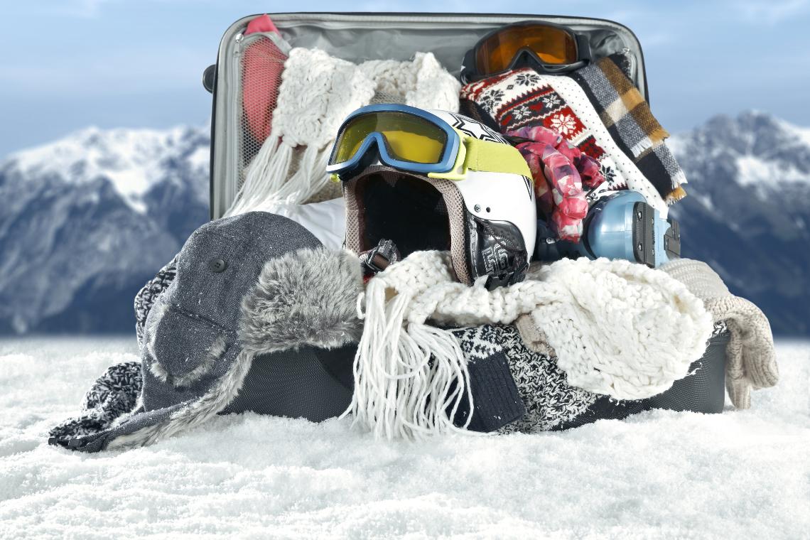 Luggage filled with winter and ski-related clothes